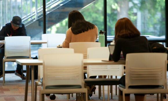 Three students sitting in a quiet area