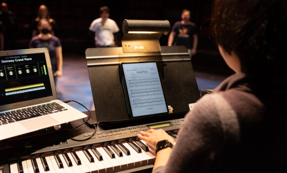 A student at a keyboard during a performance