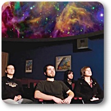 Students watch a presentation in the planetarium