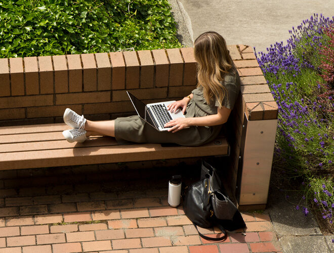 A student works on a laptop on the BC campus.