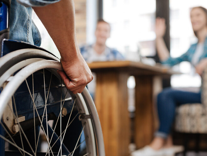 A person in wheelchair joins a study group with other students.