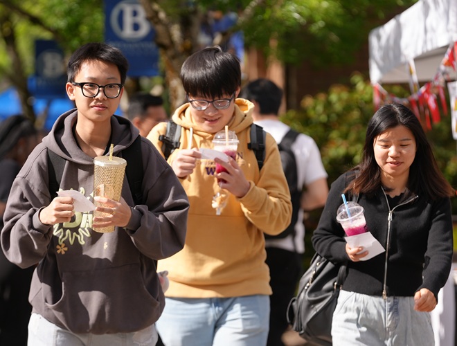 Students walking with drinks and snacks