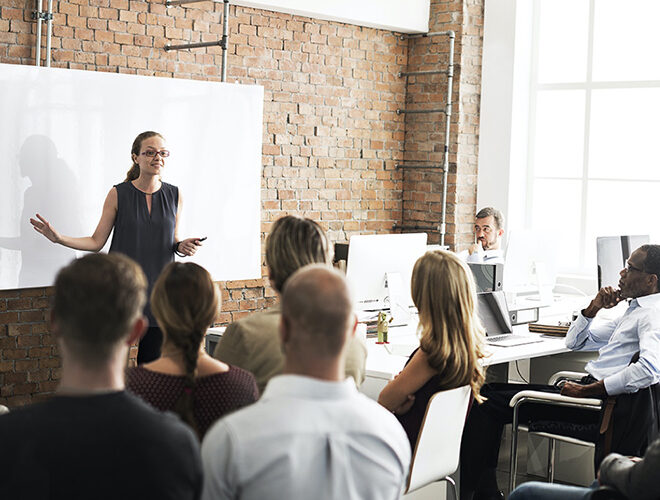 An instructor leads a professional training class.