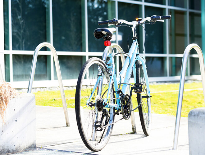 A bicycle stands in a bike rack.