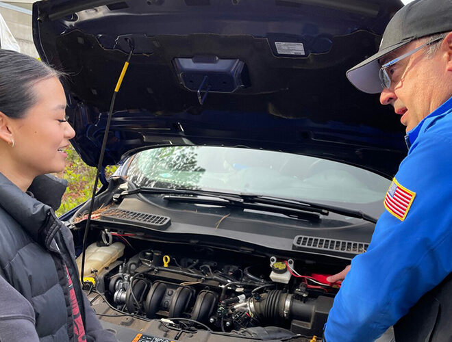 A student receives vehicle assistance.