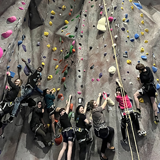 BC students rock climb indoors.