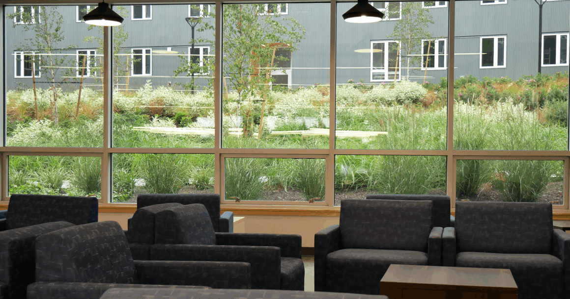 Main lobby with plenty of seating and lots of greenery visible through the huge windows