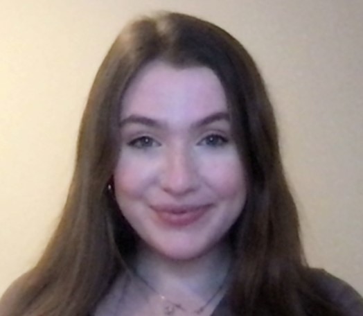 Woman with brown hair smiling.