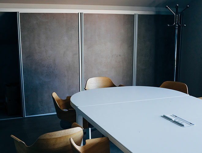 Oval table and chairs in modern meeting room.