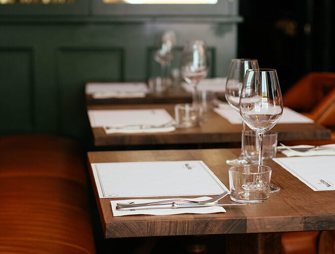 Clear Long-stemmed Wine Glass on Brown Table