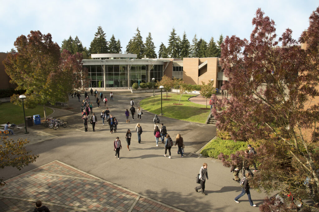 Students walking to class and C building in the background.