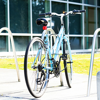 A bicycle is parked in bike rack.