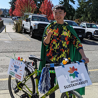 A student poses with a BC rental bike.