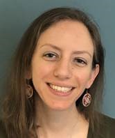 Dr. Christina smiling, wearing round earrings