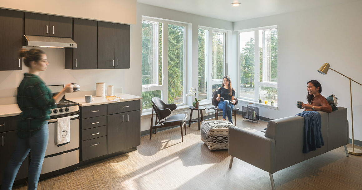 Students share drinks in the kitchen in BC student housing.