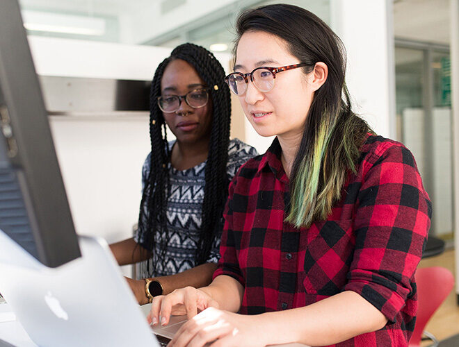 Students work together on a computer.