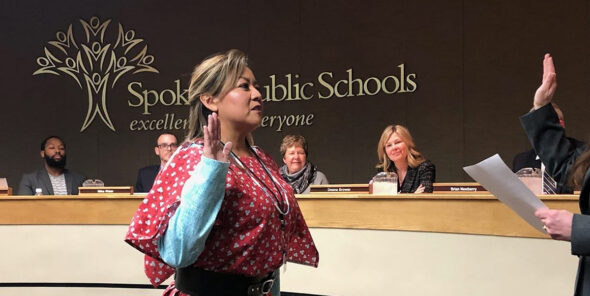 Jenny Slagle raises right hand in oath at Spokane Public Schools school board meeting.