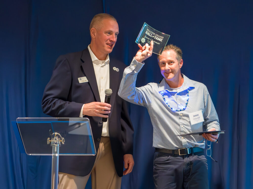 Bellevue College Athletics Director Jeremy Eggers congratulating Jason Chapman on Hall of Fame induction.