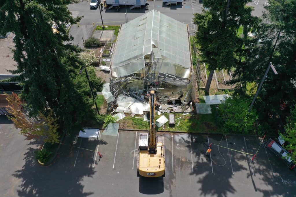 Aerial shot of greenhouse with crane. 