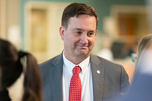 Man smiles at person. 