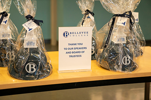 Hard hats in gift bags on a table. 