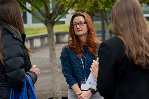 Woman looks at two women.