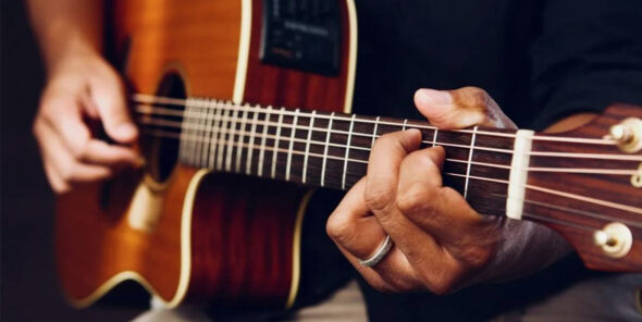 Hands playing guitar.