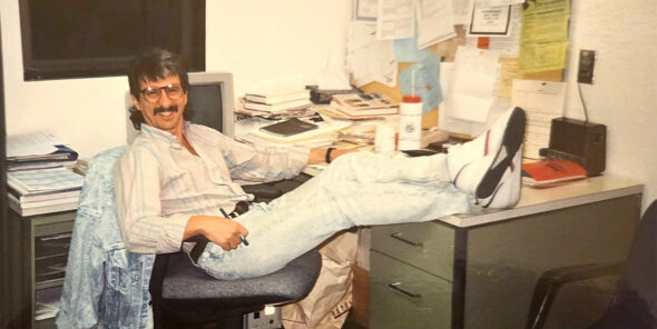 Daniel J. LaFond sitting at desk with feet up at his Bellevue College office.