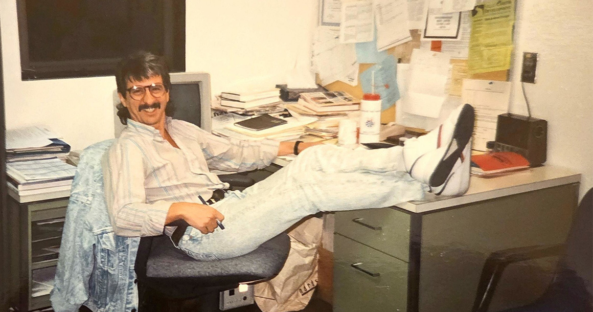 Daniel J. LaFond sitting at desk with feet up at his Bellevue College office.
