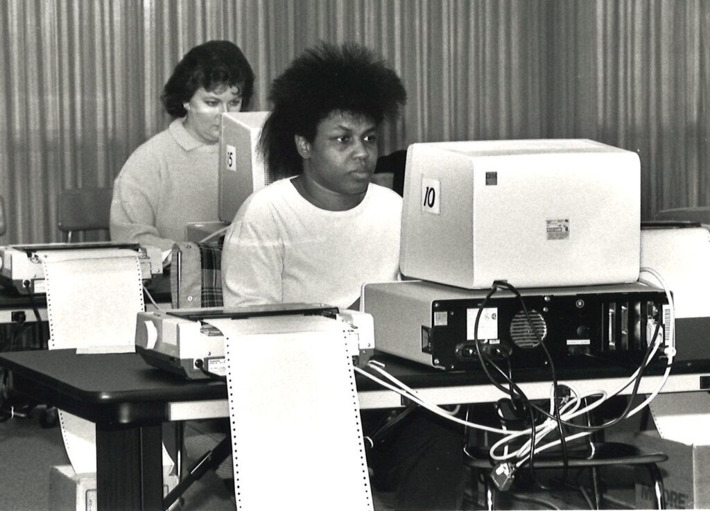 Two students working in an early computer lab