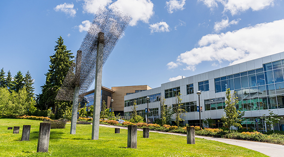 A metal sculpture rises toward the sky in front of BC's T Building.