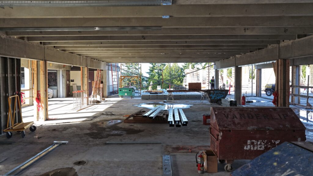 Cement ceiling and flooring with pillars on the sides.