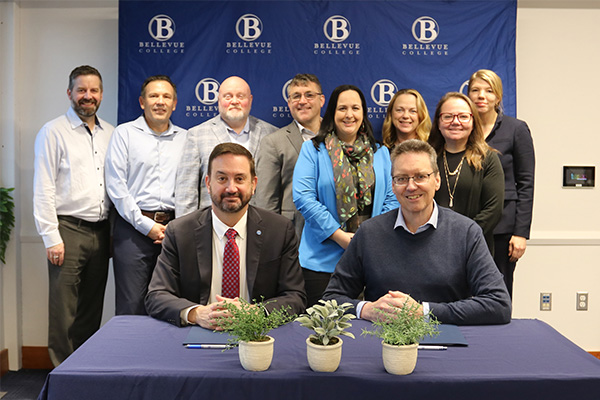 From front left: Bellevue College President David May and Western Washington University Provost and Executive Vice President Brad Johnson. From back left: Bellevue College Vice President of Information Technology Services Rodger Harrison, Bellevue College Vice President of Administrative Services Jorge de la Torre, Bellevue College Vice President of Institutional Advancement and Executive Director of the Bellevue College Foundation Sean Marsh, Western Washington University Vice Provost of Outreach and Continuing Education Robert Squires, Bellevue College Provost and Vice President of Academic Affairs Jess Clark, Western Washington University Assistant Vice President for Advancement Services Many Hanousek, Bellevue College Vice President of Student Affairs Judith Hernández Chapar, Western Washington University Chief of Staff Becca Kenna-Schenk.