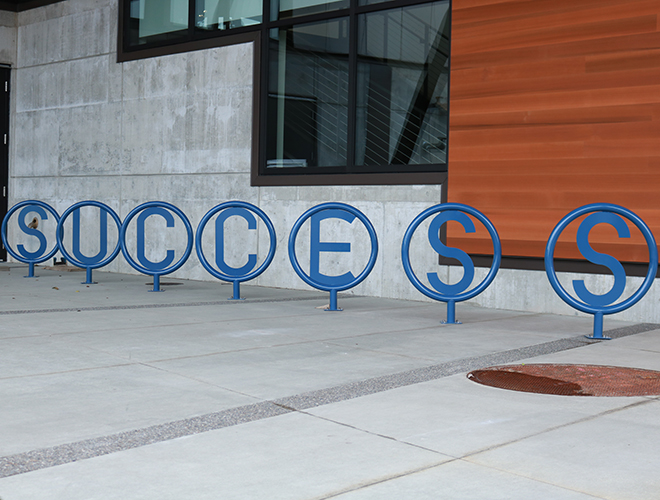 The bicycle racks in front of the U Building spell out the word 