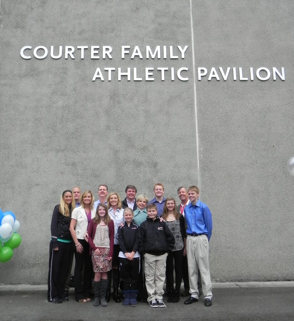 The Courter family stands in front of the Courter Family Athletic Pavilion.