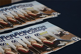 Several magazines fanned out on a dark table.