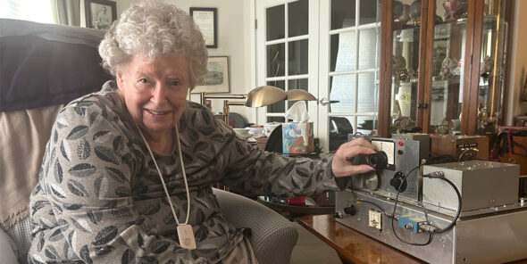 Joan Baker sitting next to a Doppler ultrasound machine.