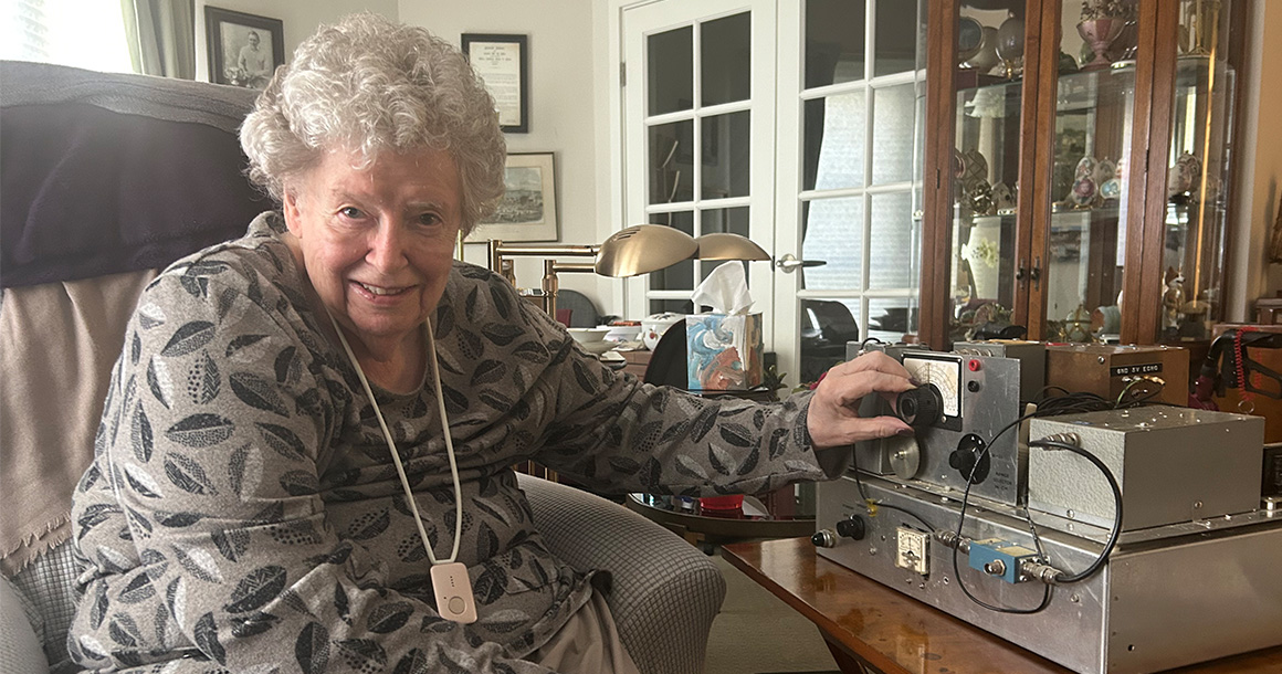 Joan Baker sitting next to a Doppler ultrasound machine.