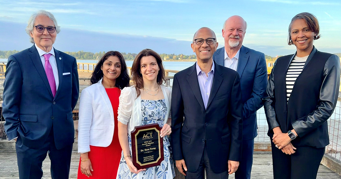 The Bellevue College Board of Trustees stands with faculty member Sara Farag, holding an award.