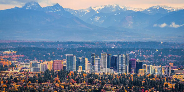 Mountains with a city and trees below.