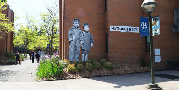 Never Again is Now mural on wall outside at Bellevue College campus.
