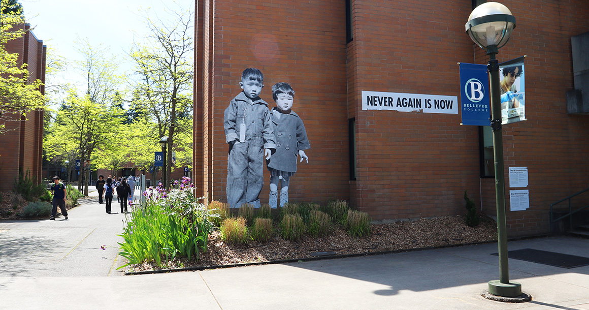 Never Again is Now mural on wall outside at Bellevue College campus.