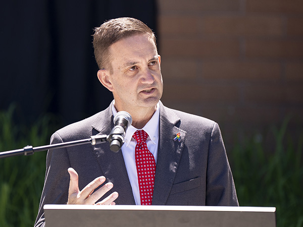 Bellevue College President David May speaks at podium.