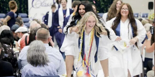 Naselle grads Mylee Dunagan and Aine Martin make a celebratory exit following the commencement ceremony on Saturday, June 13, at Naselle High School.