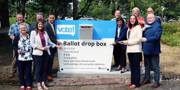 King County Elections and Bellevue College leadership stand with elected officials at the new ballot drop box at Bellevue College.