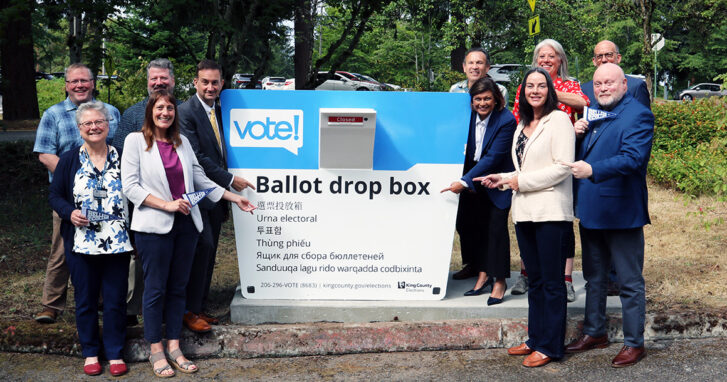King County Elections and Bellevue College leadership stand with elected officials at the new ballot drop box at Bellevue College.