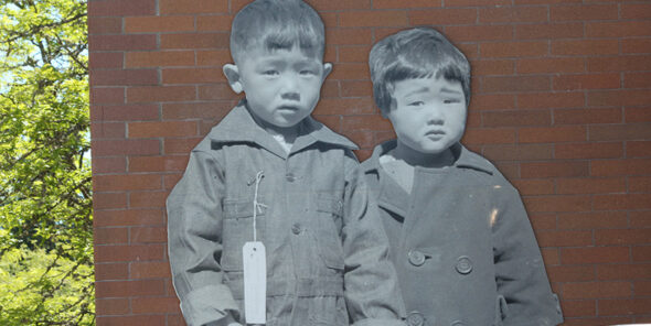 Mural of two Japanese children during World War II on Bellevue College campus wall.
