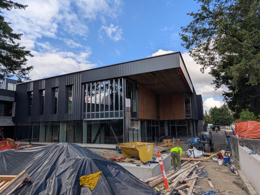 W Building exterior with blue sky and construction environment.