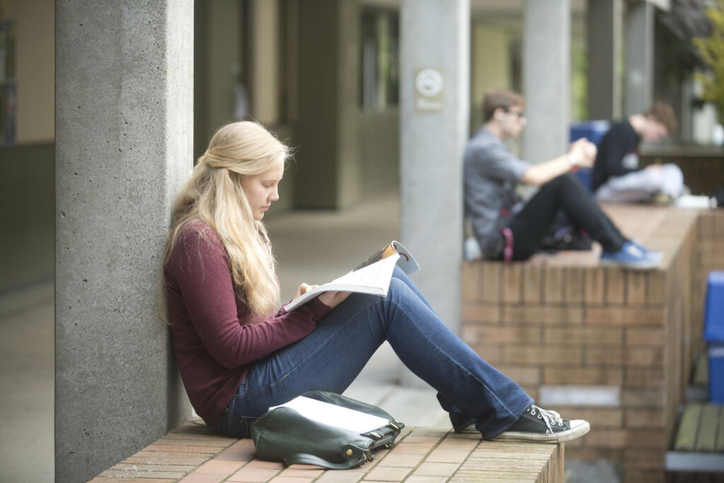 Students read and study outside on campus.