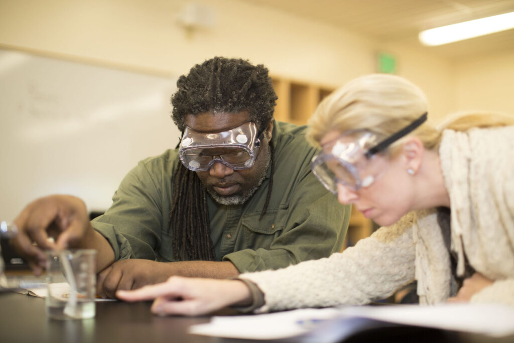 Students examine results in the chemistry lab.